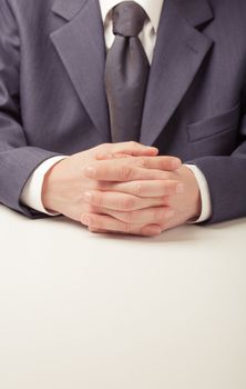 Man in business suit sitting at the table