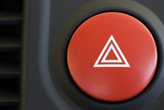 a hazard warning flasher button from a car dashboard