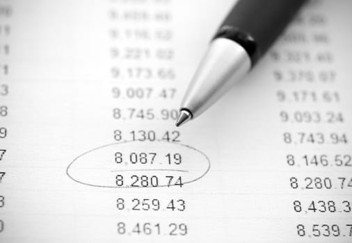 Business still-life: financial report and pen