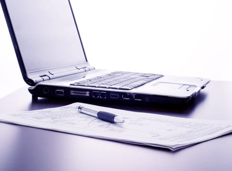 Working in the office: computer, papers and pen

