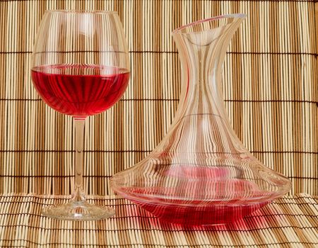 Still life with decanter and goblet on mat