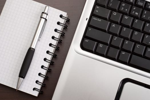 Working in the office: computer, papers and pen
