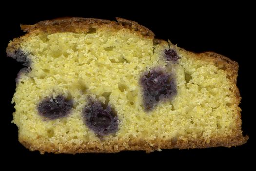 slice of homemade cornbread with blueberries isolated on black