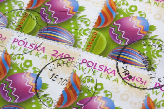 Easter (Wielkanoc in Polish) - colorful eggs and floral folk decorations on old post stamps from Poland canceled in Warsaw 