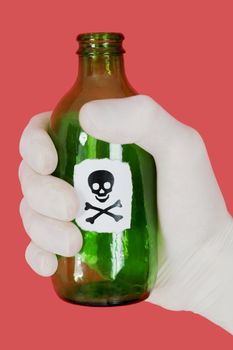 Green bottle with skull and crossbones on hand