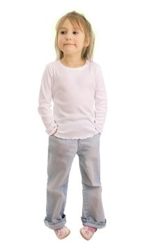 Girl of five years in a white shirt and blue jeans isolated on a white background. She smiles, the look is directed towards
