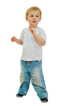 Boy of three years, dressed in a white shirt and blue jeans poses