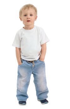 Boy of three years, dressed in a white shirt and blue jeans poses