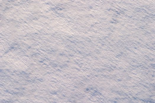 Texture of the snow. Thin snow crust on the surface of the frozen lake. Natural sunlight emphasizes texture. Pattern # 1