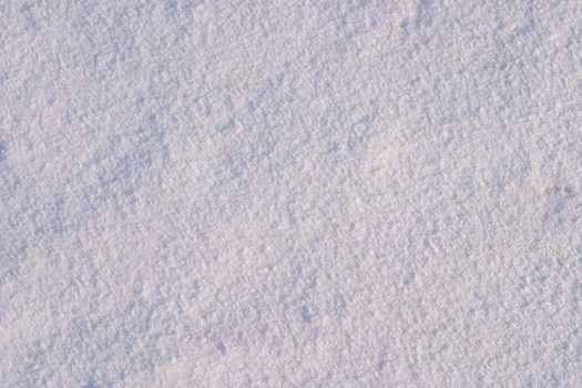 Texture of the snow. Thin snow crust on the surface of the frozen lake. Natural sunlight emphasizes texture. Pattern # 2