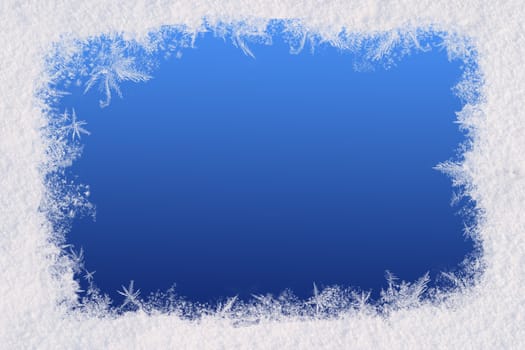 Winter frame for the congratulations. The blue background and natural snow. Space for text