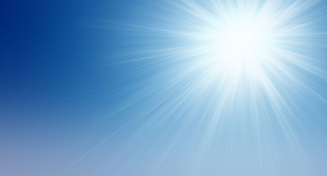 Natural background. Bright sun shining in the clear blue sky. The idea of purity, the beginning, the origins and prosperity and eternity