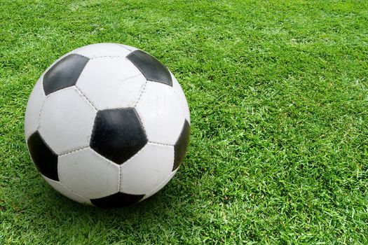 Soccer ball on ground. In the right part of the image space for text
