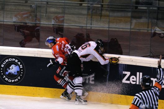 ZELL AM SEE; AUSTRIA - SEPTEMBER 4: Red Bull Salute Tournament Semifinal. Marc Reichert (Bern) hits Jens Baxmann. Game between SC Bern and Eisbaeren Berlin (Result 1-5) on September 4, 2010.