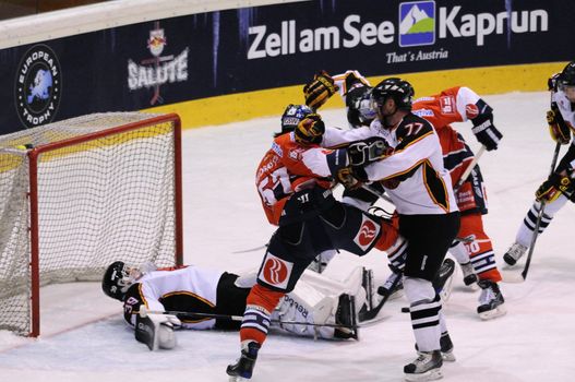 ZELL AM SEE; AUSTRIA - SEPTEMBER 4: Red Bull Salute Tournament Semifinal. Travis Roche (Bern) punches Daniel Weiss in a scrum).  Game between SC Bern and Eisbaeren Berlin (Result 1-5) on September 4, 2010.