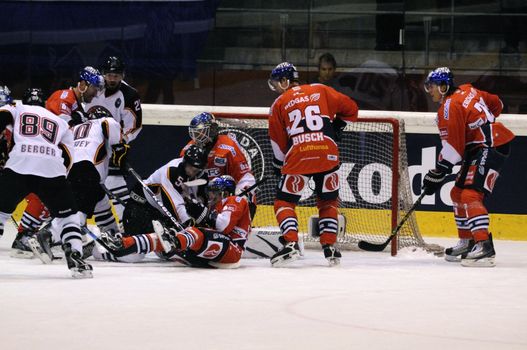 ZELL AM SEE; AUSTRIA - SEPTEMBER 4: Red Bull Salute Tournament Semifinal. Rough action in front of Berlin keeper Rob Zepp. Game between SC Bern and Eisbaeren Berlin (Result 1-5) on September 4, 2010.