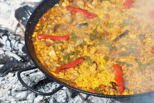 Spanish paella being cooked on an open fire