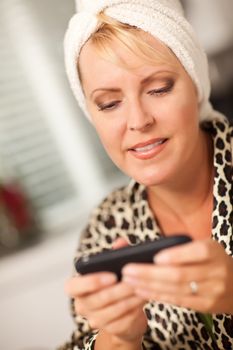 Attractive Woman Texting With Her Cell Phone with Narrow Depth of Field.