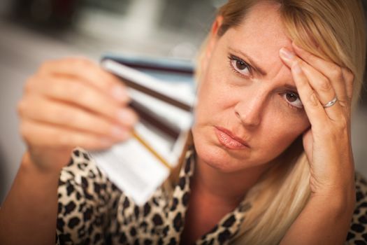 Upset Robed Woman Glaring At Her Many Credit Cards.