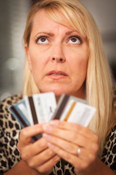 Upset Robed Woman Glaring At Her Many Credit Cards.