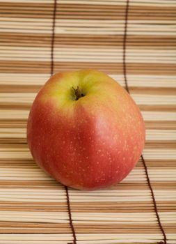 Red big apple on the wooden mat