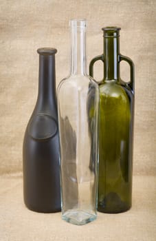 Bottle for champagne, bottle for wine and glass bottle on sacking
