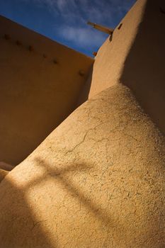 Shadow of a cross on the church wall