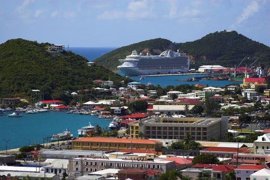 Tropical town - tropical island with a small red-roof town with the background of the large cruise ship. St. Thomas, USVI
