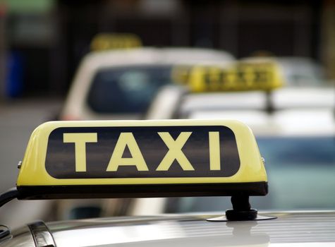 Taxi signs on top of taxis in Frankfurt, Germany
