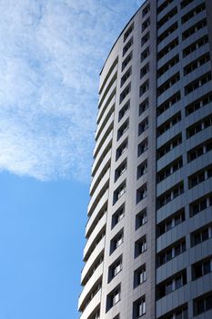 Closeup of high modern building on blue sky background