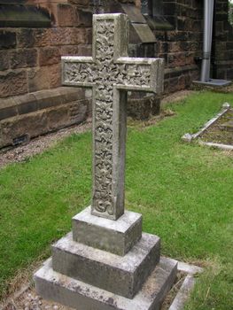 old stone cross in a churchyard