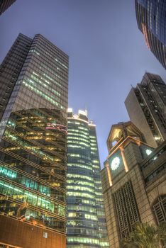 Modern office buildings and skyscrapers exterior in night.