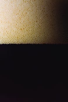 bubbles of dark beer in a glass