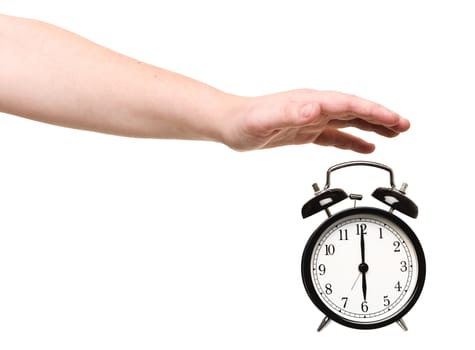 Hand turning of the alarm clock isolated on white background