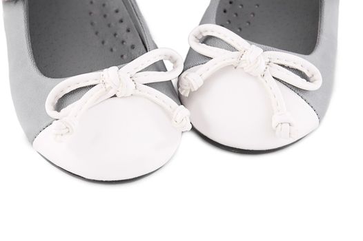 Pair of gray and white baby shoes with bows