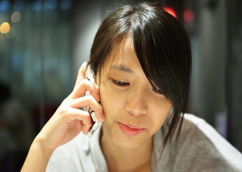 woman talking on the phone in restaurant