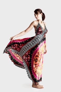 Beautiful fashion woman posing with a colorful dress