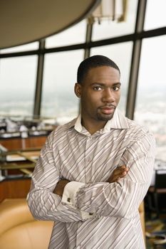 African American mid adult man with arms crossed looking at viewer.