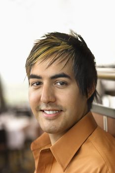 Portrait of Hispanic mid adult man smiling at viewer.