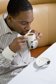 African American mid adult man drinking expresso.