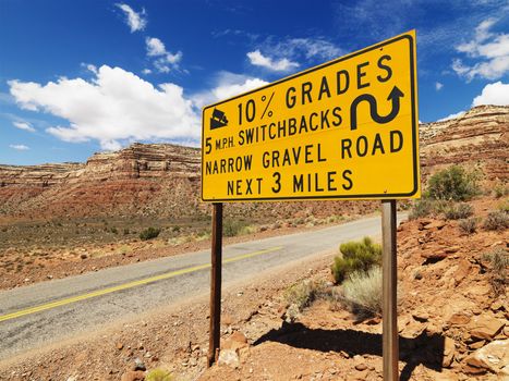 Road sign warning steep grade in Utah mountainous area.