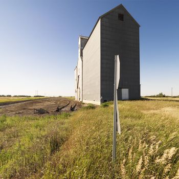 Agricultural grain elevator in rural field.