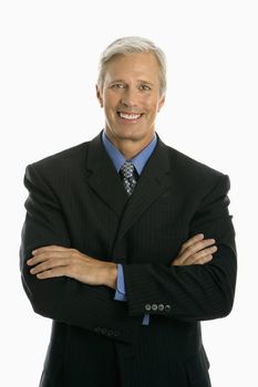Middle aged Caucasian man in business suit smiling at viewer with arms crossed.