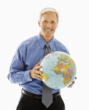 Middle aged Caucasian man holding globe and smiling at viewer.