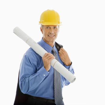 Caucasian middle aged businessman holding blueprints and wearing hard hat.