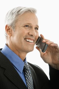 Caucasian middle aged man smiling and talking on cell phone.