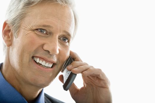 Close up of Caucasian middle aged man smiling and talking on cell phone.