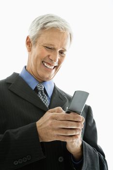 Caucasian middle aged man smiling and text messaging on cell phone.