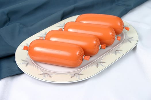 Ready boiled sausage on a plate