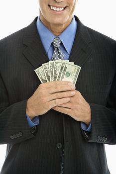 Caucasian middle aged businessman holding fist full of cash.